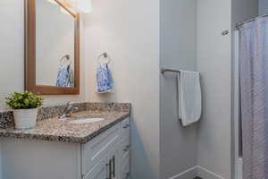 Bathroom featuring vanity and baseboards