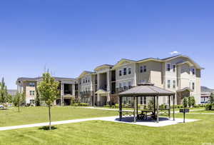 Surrounding community with a lawn, a gazebo, and a residential view