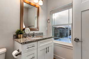 Half bathroom with vanity and healthy amount of natural light