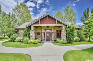 Craftsman house with a porch, stone siding, and a front yard