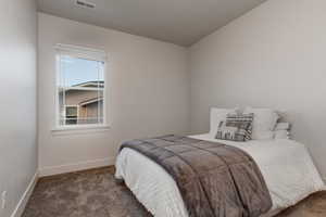 Carpeted bedroom with baseboards