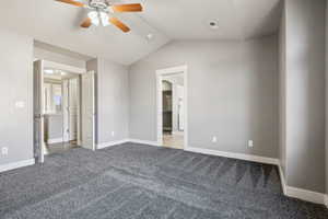 Unfurnished bedroom featuring carpet, lofted ceiling, and ceiling fan