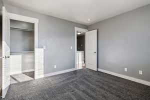 Unfurnished bedroom featuring carpet floors and a closet