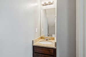 Half bathroom with vanity and toilet