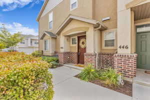 Property entrance featuring brick siding and stucco siding