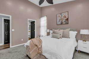 Carpeted bedroom with connected bathroom and baseboards