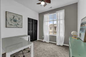 Office featuring light colored carpet and ceiling fan