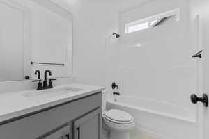 Bathroom featuring shower / tub combination and vanity