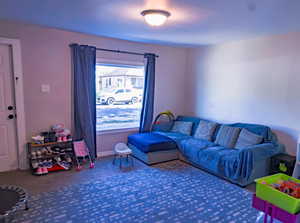Living area with carpet and baseboards