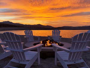 View of patio / terrace with a fire pit and a water and mountain view