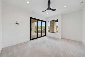 Empty room featuring light colored carpet, recessed lighting, and a ceiling fan
