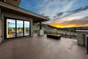 View of patio with a fire pit and a mountain view
