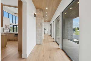Corridor with recessed lighting and light wood-type flooring