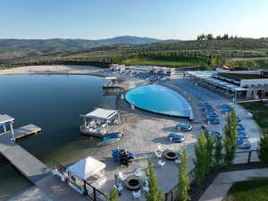 Drone / aerial view of a mountain backdrop and a pool area