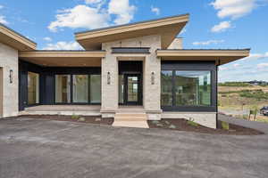 View of exterior entry featuring stone siding