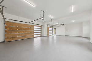 Garage with baseboards and a garage door opener