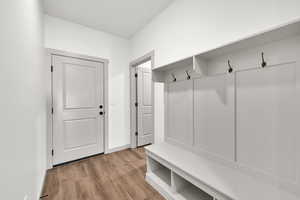 Mudroom featuring light wood-type flooring and baseboards
