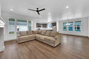 Living area featuring ceiling fan, recessed lighting, a chandelier, and wood finished floors