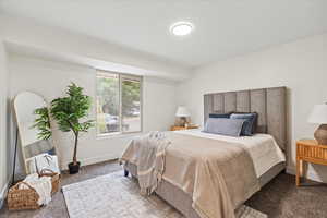 Bedroom featuring carpet flooring and baseboards