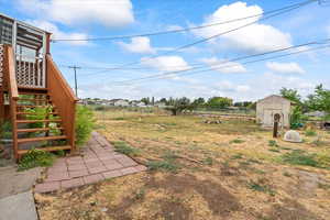 View of yard with stairway and a shed