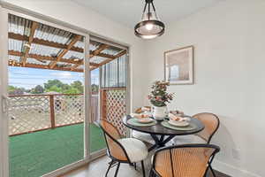 Dining space with wood finished floors and baseboards