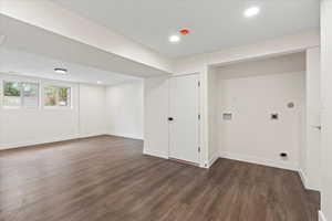 Below grade area with recessed lighting and dark wood-style flooring