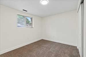Unfurnished bedroom with a closet and carpet