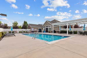 Community pool with a patio area and a pergola