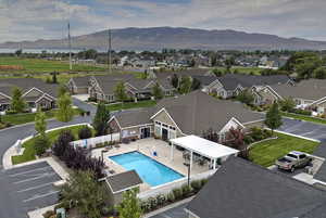 Community pool with a mountain view, a residential view, and a patio area
