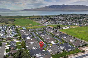 Aerial view of property's location with nearby suburban area and a water and mountain view