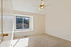 Spare room featuring carpet and baseboards