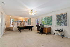 Office featuring light colored carpet, crown molding, and ceiling fan