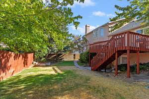 Fenced yard with stairs and a wooden deck