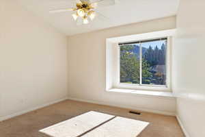 Spare room featuring carpet flooring and ceiling fan
