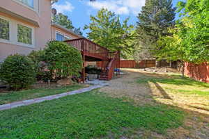 Fenced backyard featuring stairway and a deck