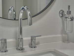 Bathroom view of a sink and a textured wall