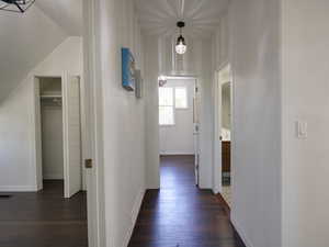 Hall featuring dark wood-style flooring and a textured ceiling