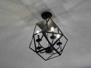 Detailed view of a chandelier and a textured wall
