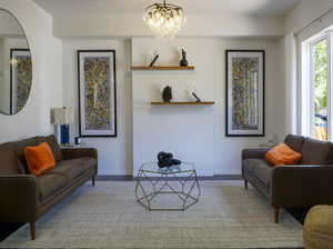 Living room with baseboards and a chandelier