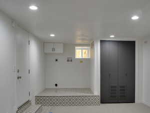 Washroom featuring recessed lighting, hookup for an electric dryer, washer hookup, and cabinet space