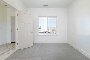 Unfurnished room with baseboards and light carpet