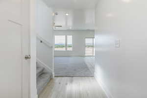 Stairs featuring wood finished floors, recessed lighting, and a ceiling fan