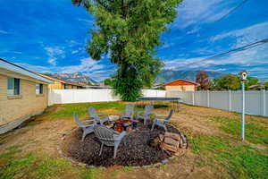 Backyard for your entertainment. Fire Pit area. Mtn Views. Fully fenced. New vinyl fence around the back yard.