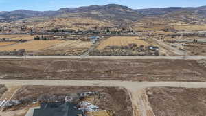 Aerial overview of property's location with a mountainous background and rural landscape