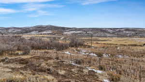 View of mountain backdrop with rural landscape