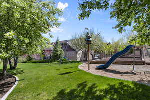 View of grassy yard with a playground