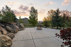 View of patio with an outdoor fire pit