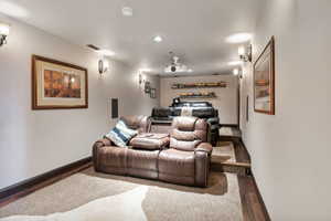 Cinema with wood finished floors and recessed lighting