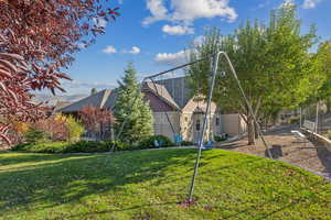Back of house with a yard
