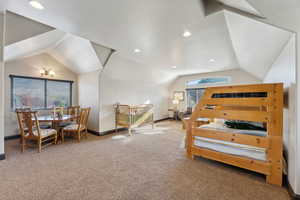 Bedroom with lofted ceiling, light carpet, and recessed lighting